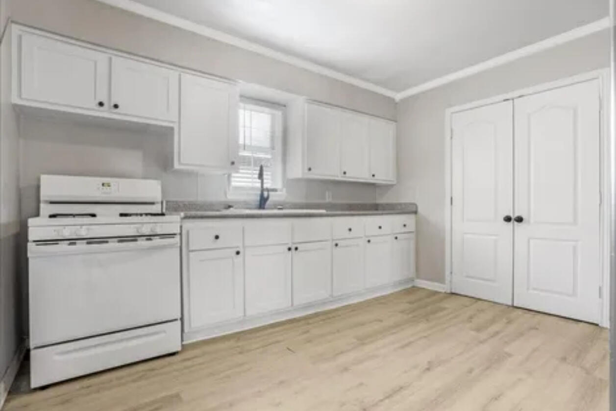 3302 Bates Street Lubbock, TX 79415 - Photo 2 of 9 a kitchen with white cabinets and white appliances