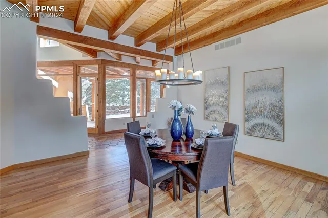 a view of a dining room with furniture window and wooden floor