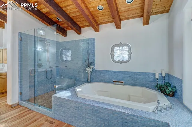 a white bath tub sitting next to a shower