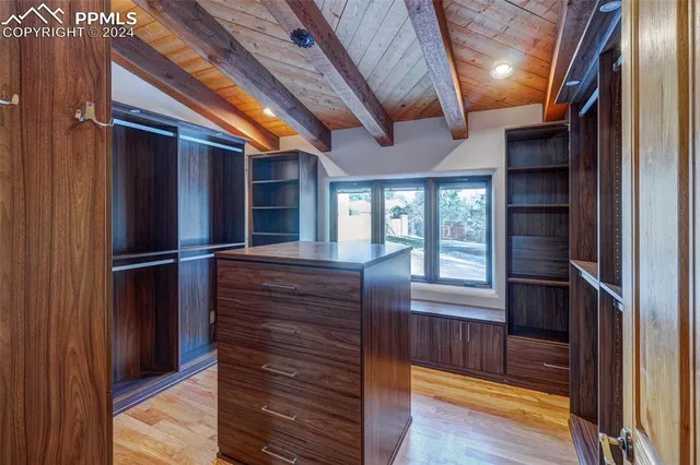 a view of walk in closet with empty room