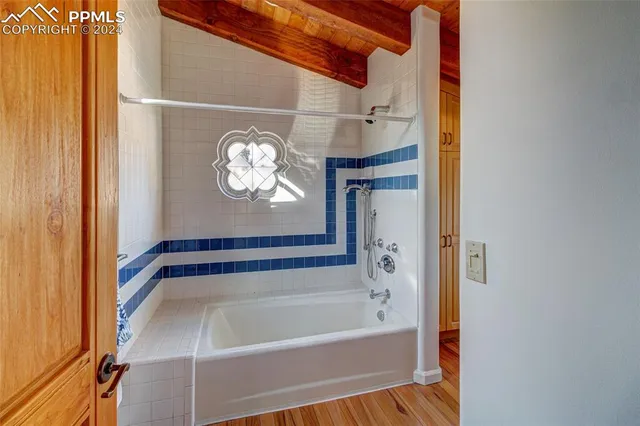 a bathroom with a bathtub and a shower