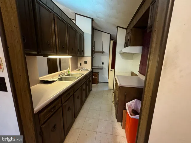 a kitchen with a sink a refrigerator and washer
