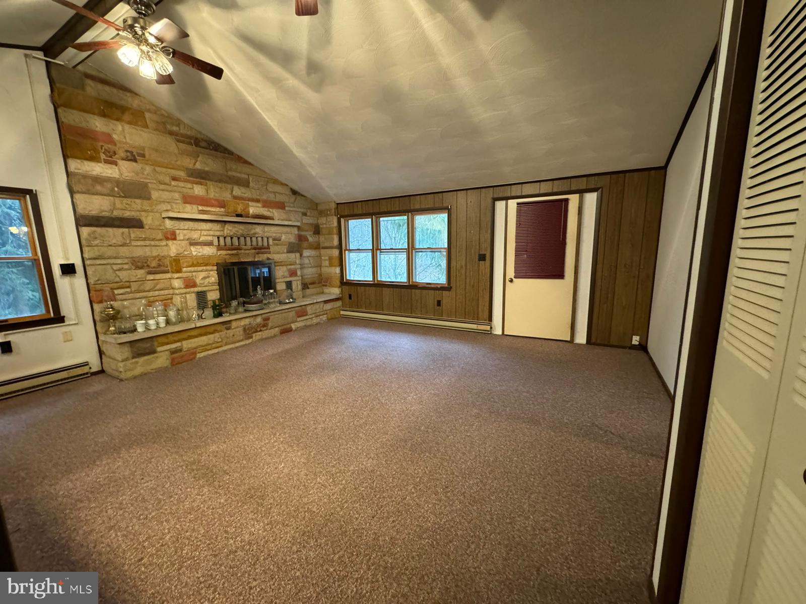 224 Shaffer Street Imler, PA 16655 - Photo 6 of 19 an empty room with fireplace and windows