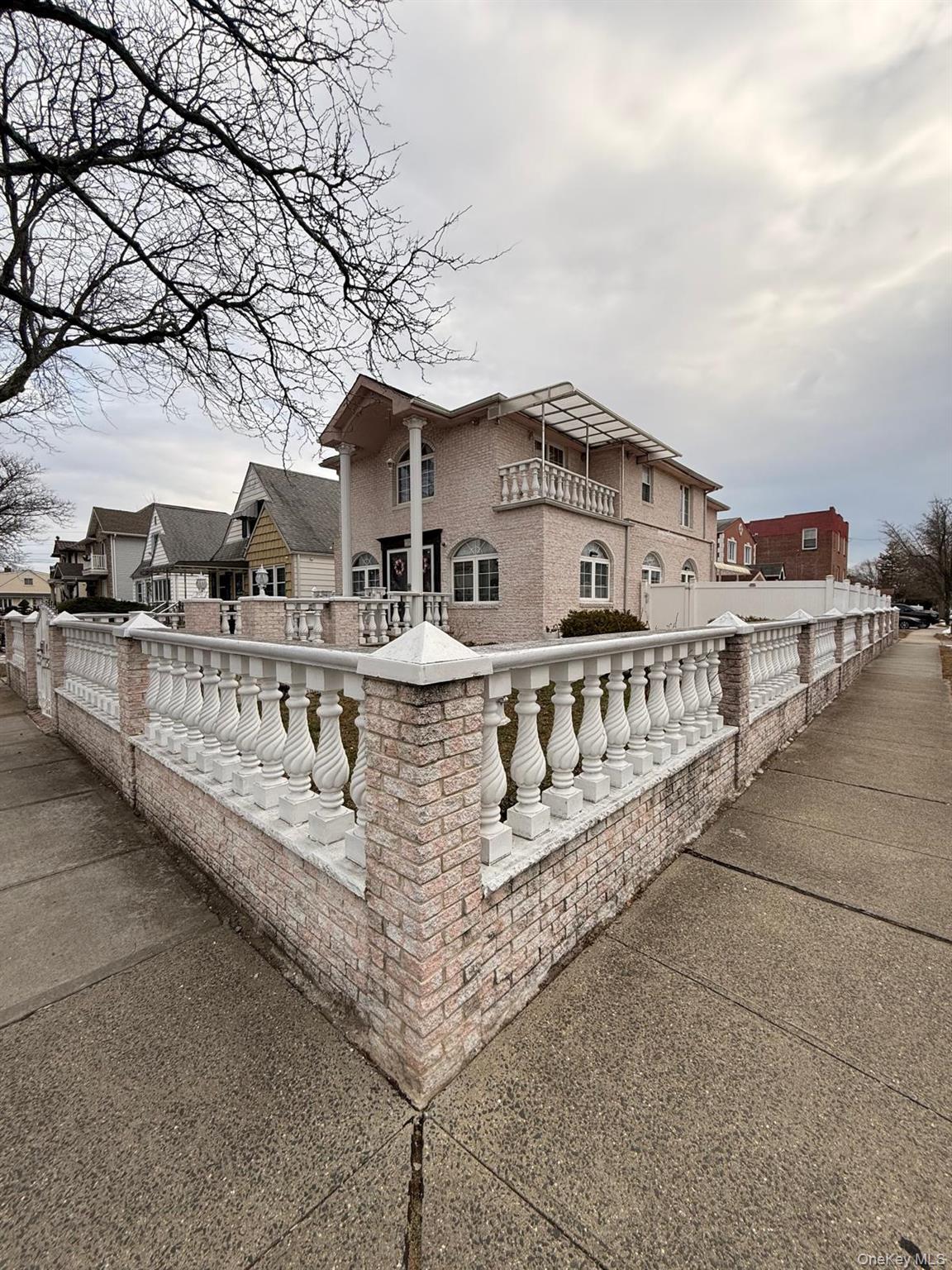 265-04 79th Avenue Queens, NY 11004 - Photo 2 of 5 a view of a house with large windows and a small yard
