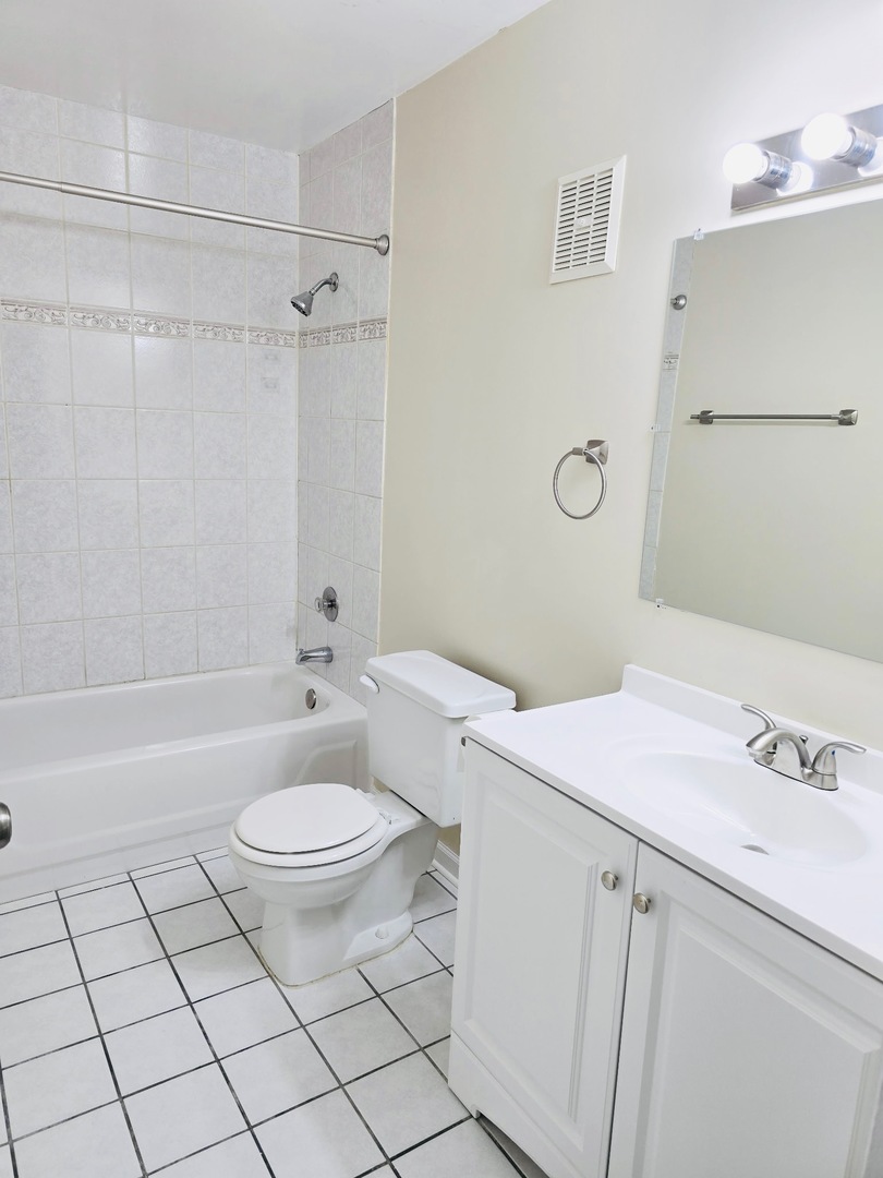 612 Waterford Road South, Unit 1B Schaumburg, IL 60193 - Photo 9 of 10 a bathroom with a sink a toilet and shower