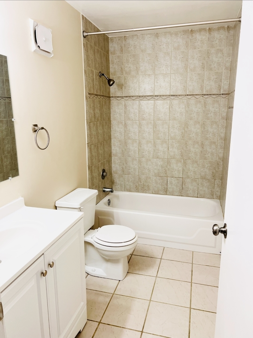 612 Waterford Road South, Unit 1B Schaumburg, IL 60193 - Photo 10 of 10 a bathroom with a sink a toilet a mirror and shower