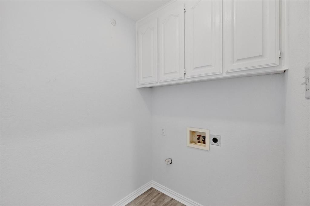 714 Ashbrook Court Euless, TX 76039 - Photo 13 of 30 Spacious laundry room with additional storage space for organization and efficiency.