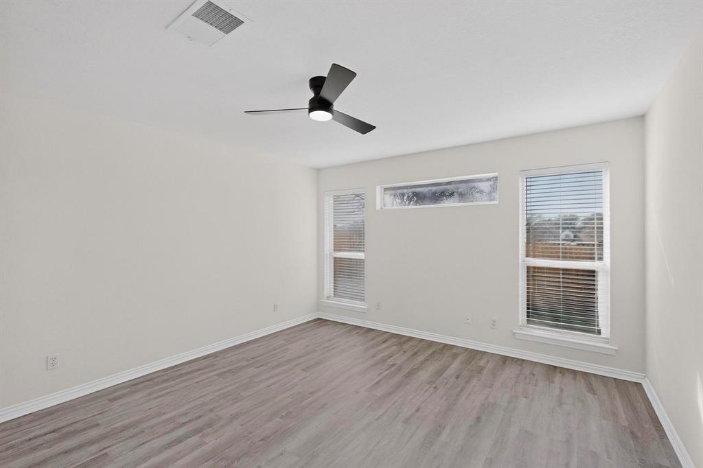 714 Ashbrook Court Euless, TX 76039 - Photo 14 of 30 Generously sized primary suite offering comfort, privacy, and plenty of natural light.
