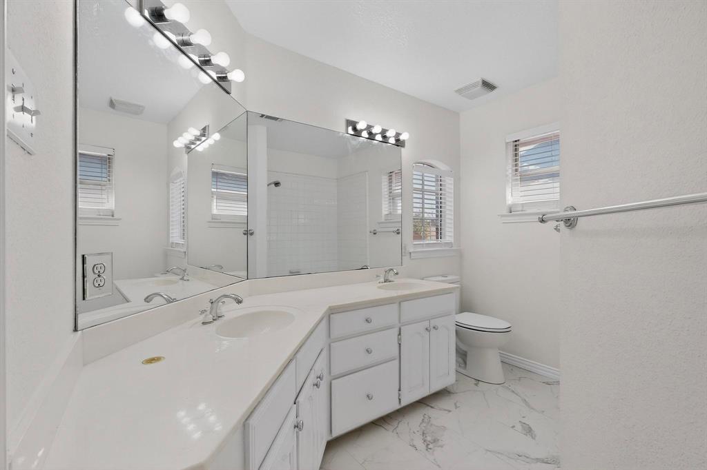 714 Ashbrook Court Euless, TX 76039 - Photo 24 of 30 Full bathroom upstairs serving the secondary bedrooms.