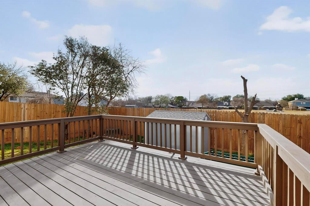 714 Ashbrook Court Euless, TX 76039 - Photo 27 of 30 Enjoy outdoor living at its best with a spacious deck designed for entertaining and a versatile grass yard offering plenty of room for pets, gatherings, or weekend fun.