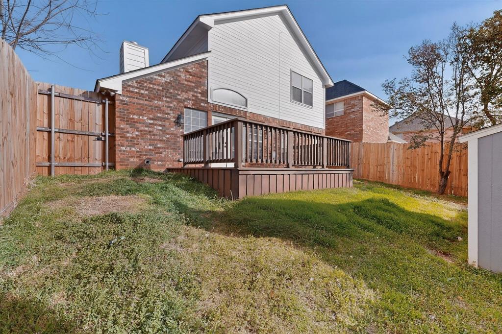 714 Ashbrook Court Euless, TX 76039 - Photo 28 of 30 Enjoy outdoor living at its best with a spacious deck designed for entertaining and a versatile grass yard offering plenty of room for pets, gatherings, or weekend fun.