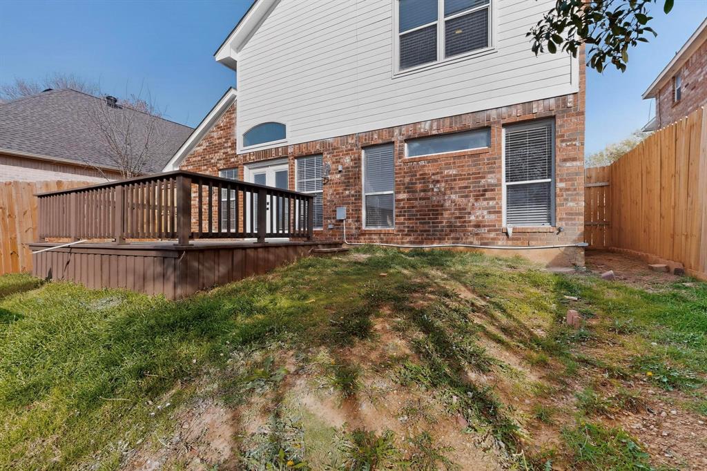 714 Ashbrook Court Euless, TX 76039 - Photo 29 of 30 Enjoy outdoor living at its best with a spacious deck designed for entertaining and a versatile grass yard offering plenty of room for pets, gatherings, or weekend fun.