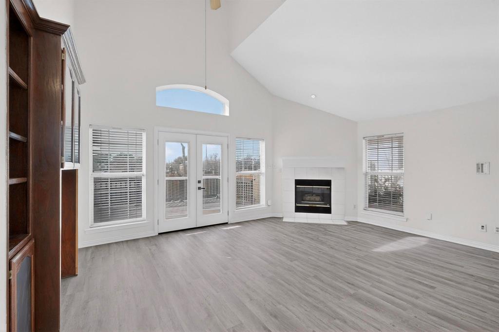 714 Ashbrook Court Euless, TX 76039 - Photo 5 of 30 The spacious living room features custom built-ins and a cozy fireplace, flowing effortlessly into the fully updated kitchen and dining area.
