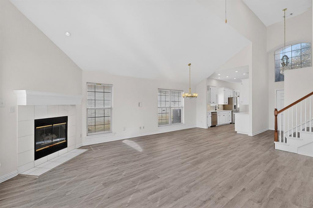 714 Ashbrook Court Euless, TX 76039 - Photo 6 of 30 The spacious living room features custom built-ins and a cozy fireplace, flowing effortlessly into the fully updated kitchen and dining area.