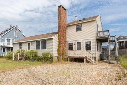 6 4th Street, Unit WINTER Newbury, MA 01951 - Photo 1 of 1 a front view of a house with a yard outdoor seating and garage
