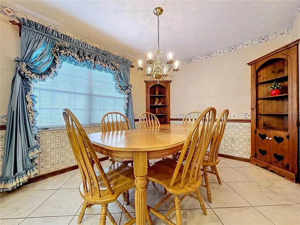 an empty room with ceiling fan and window