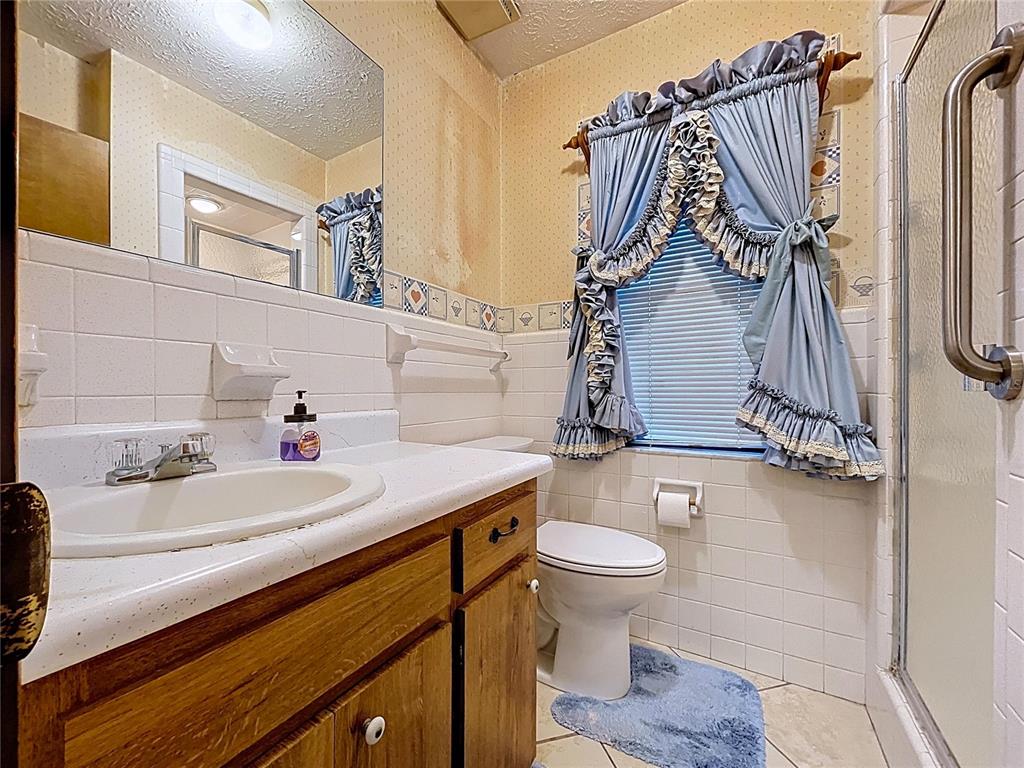 9471 McIntosh Road Dover, FL 33527 - Photo 16 of 34 a bathroom with a sink toilet and shower