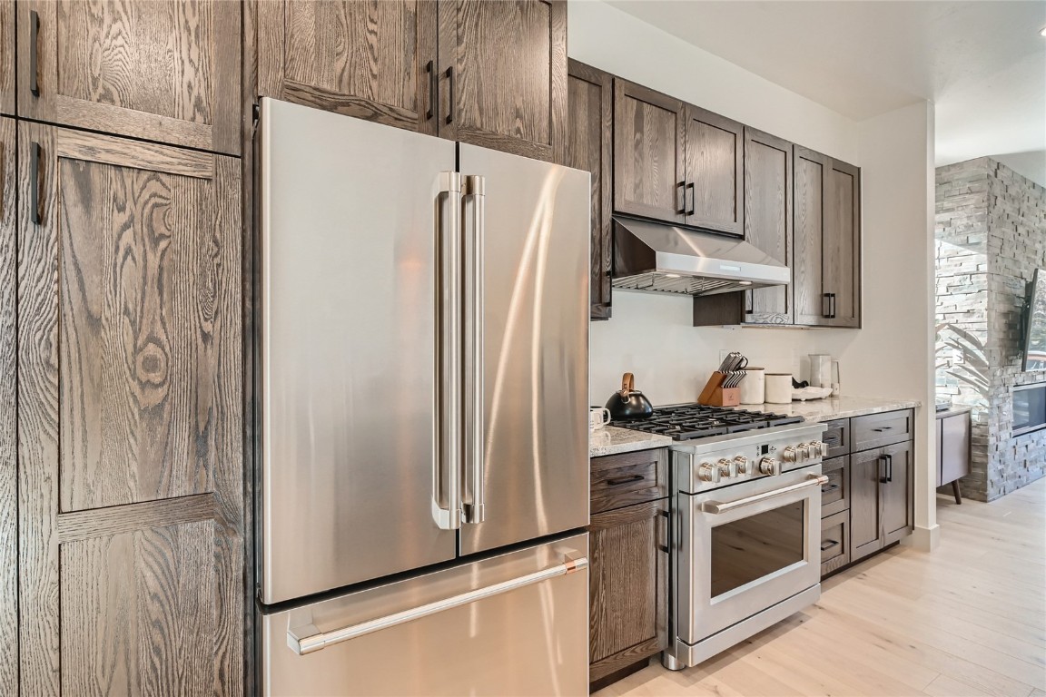 46 6th Street, Unit A1 Silverthorne, CO 80498 - Photo 11 of 28 a kitchen with stainless steel appliances a refrigerator stove and cabinets