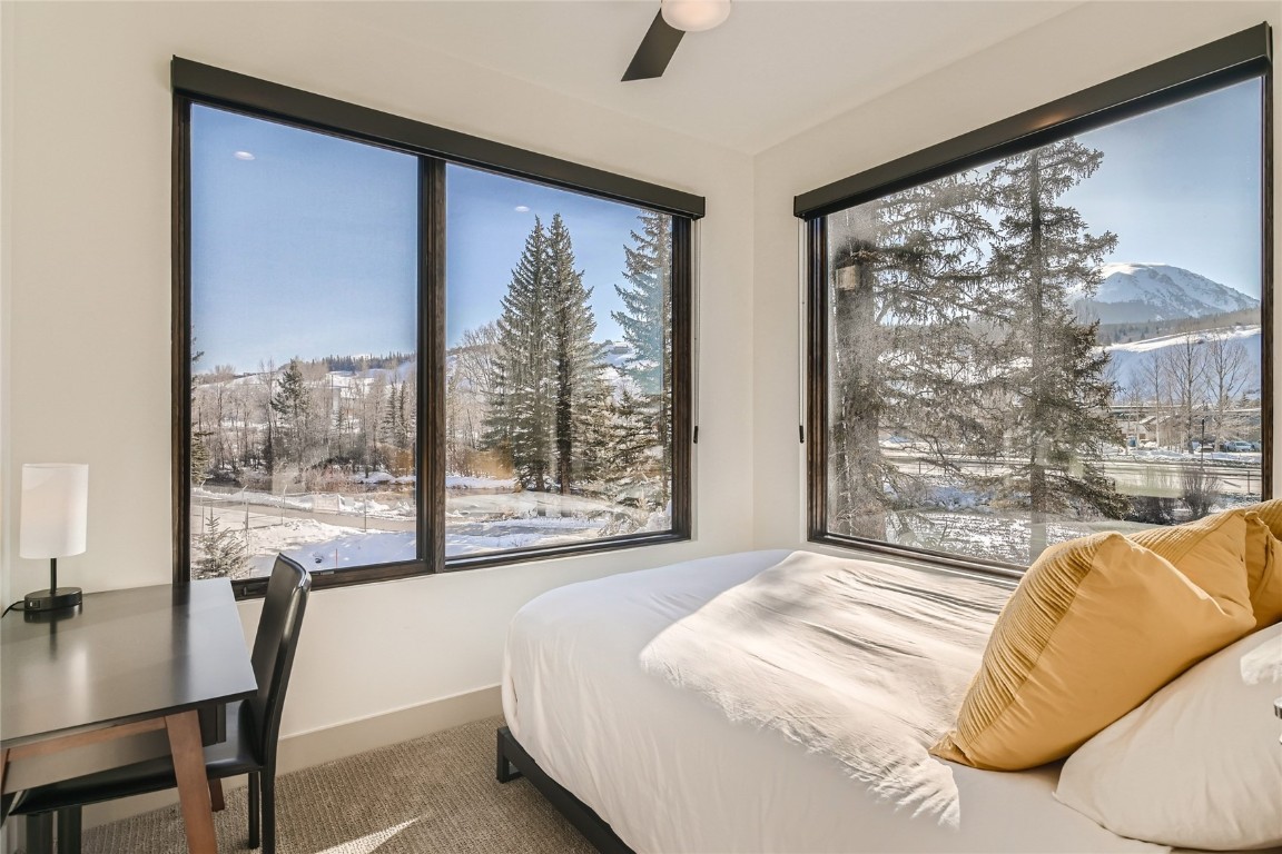 46 6th Street, Unit A1 Silverthorne, CO 80498 - Photo 13 of 28 a bedroom with a large window and a bed