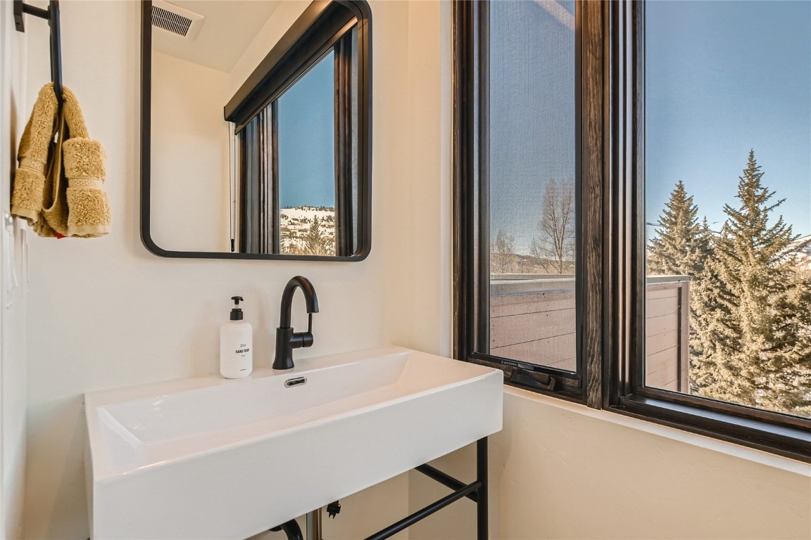 46 6th Street, Unit A1 Silverthorne, CO 80498 - Photo 23 of 28 a bathroom with a sink and a mirror