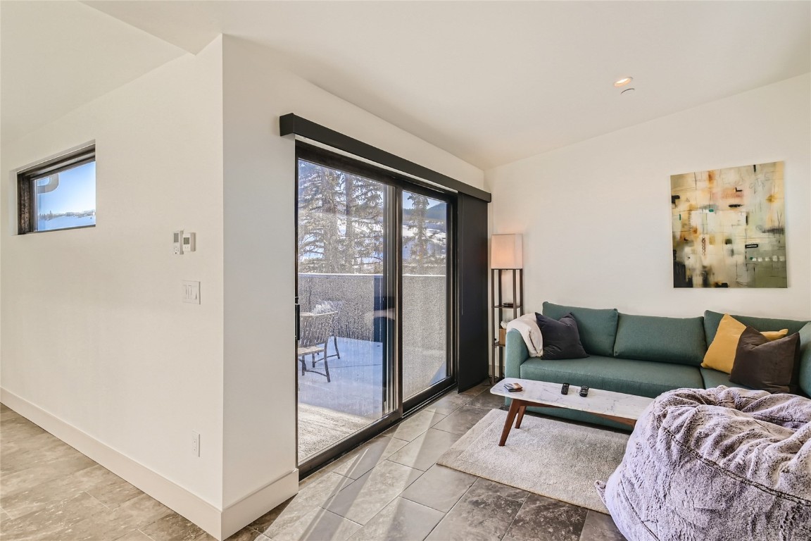 46 6th Street, Unit A1 Silverthorne, CO 80498 - Photo 24 of 28 a living room with furniture and a floor to ceiling window