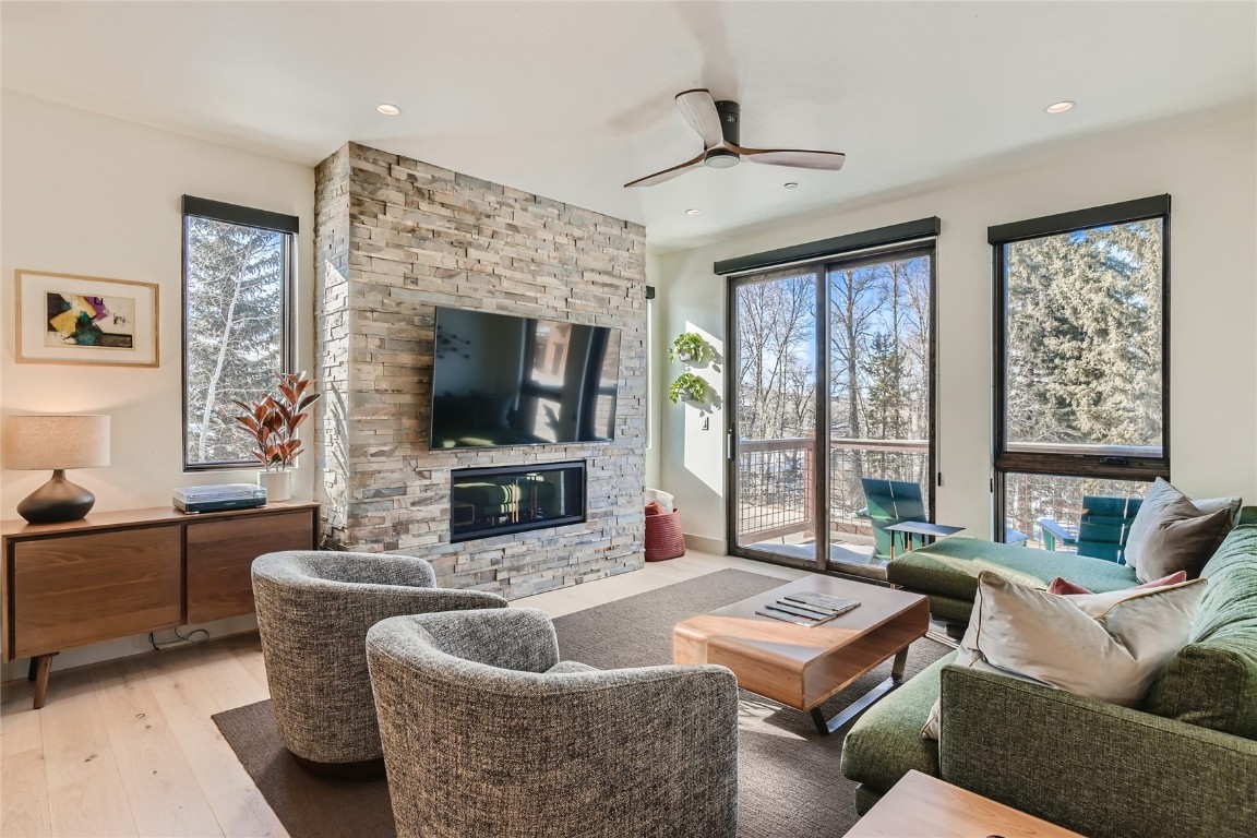 46 6th Street, Unit A1 Silverthorne, CO 80498 - Photo 6 of 28 a living room with furniture a flat screen tv and a large window