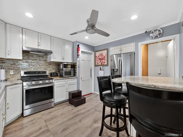 a kitchen with stainless steel appliances granite countertop a stove a sink and a refrigerator