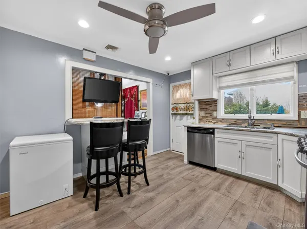 a kitchen with a table chairs refrigerator and microwave