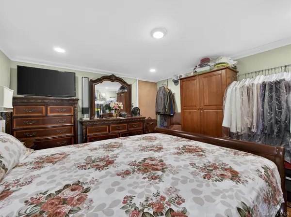 a bed room with a bed and a television