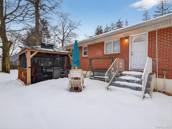 a view of house with outdoor seating area