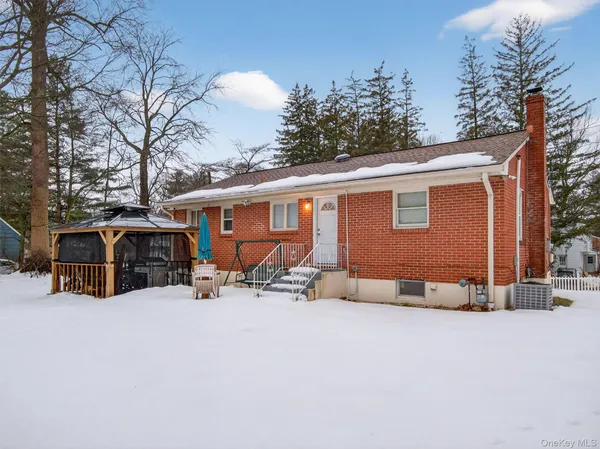 a view of a house with a yard covered in snow