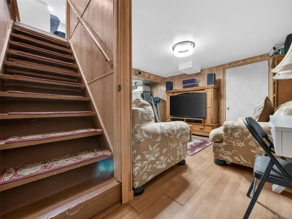a bedroom with furniture and a flat screen tv