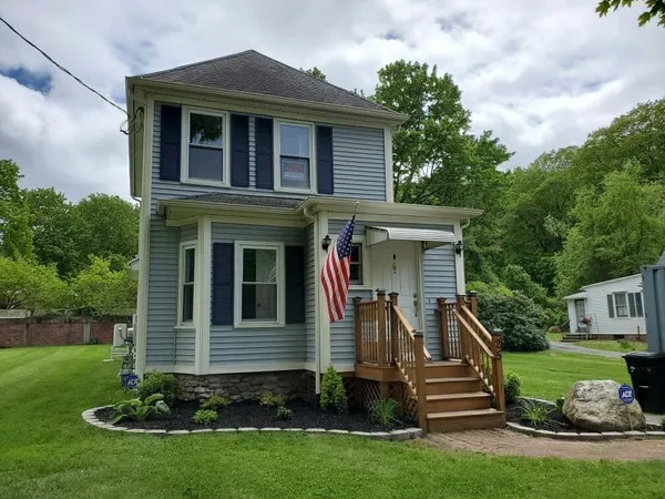 a front view of a house with a yard