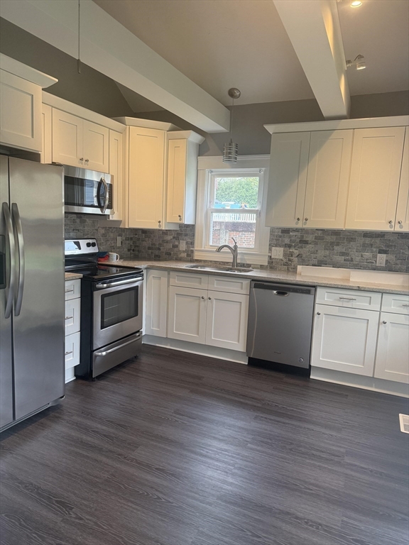 25 Chester Street Worcester, MA 01605 - Photo 2 of 8 a kitchen with stainless steel appliances granite countertop a sink a stove a refrigerator and cabinets
