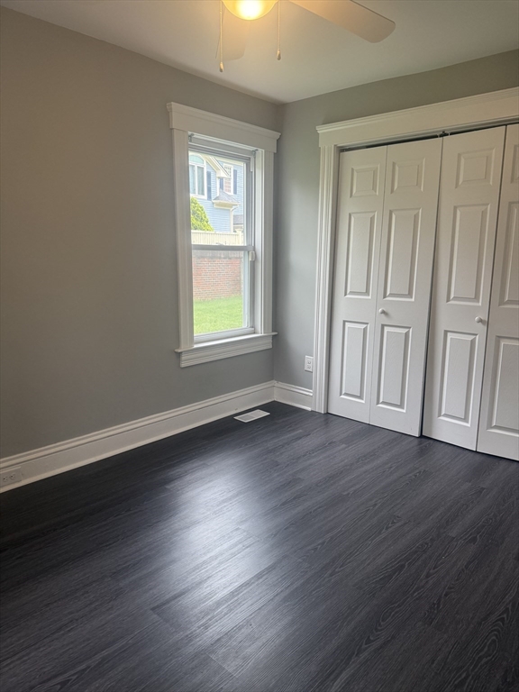 25 Chester Street Worcester, MA 01605 - Photo 3 of 8 an empty room with wooden floor and windows