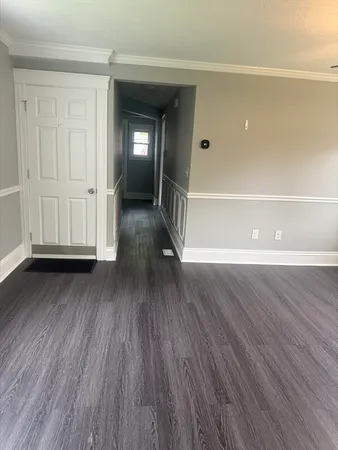 a view of a room with wooden floor and window