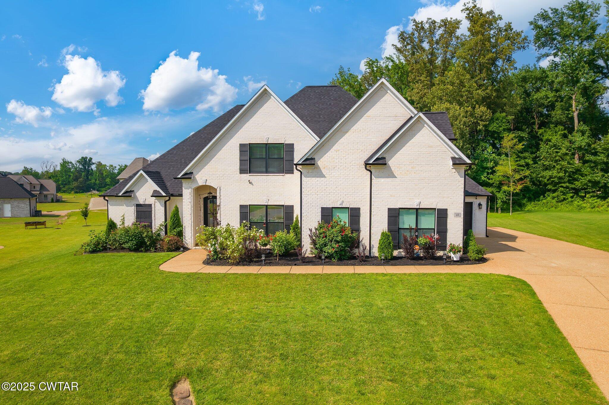 a front view of house with yard and green space