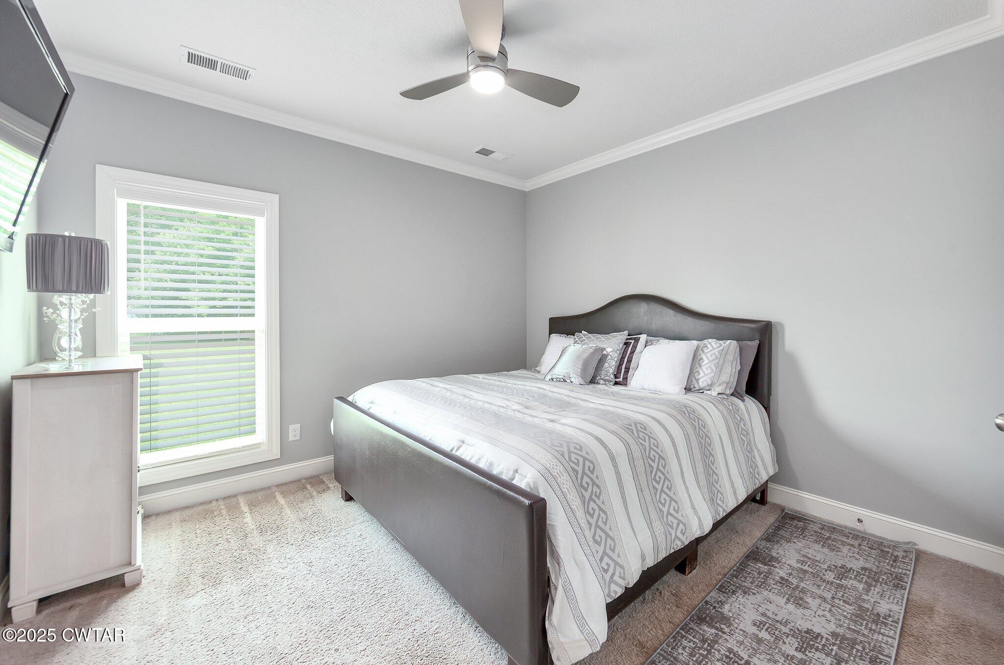 63 Westcott Cove Jackson, TN 38305 - Photo 20 of 31 a bedroom with a bed and a window