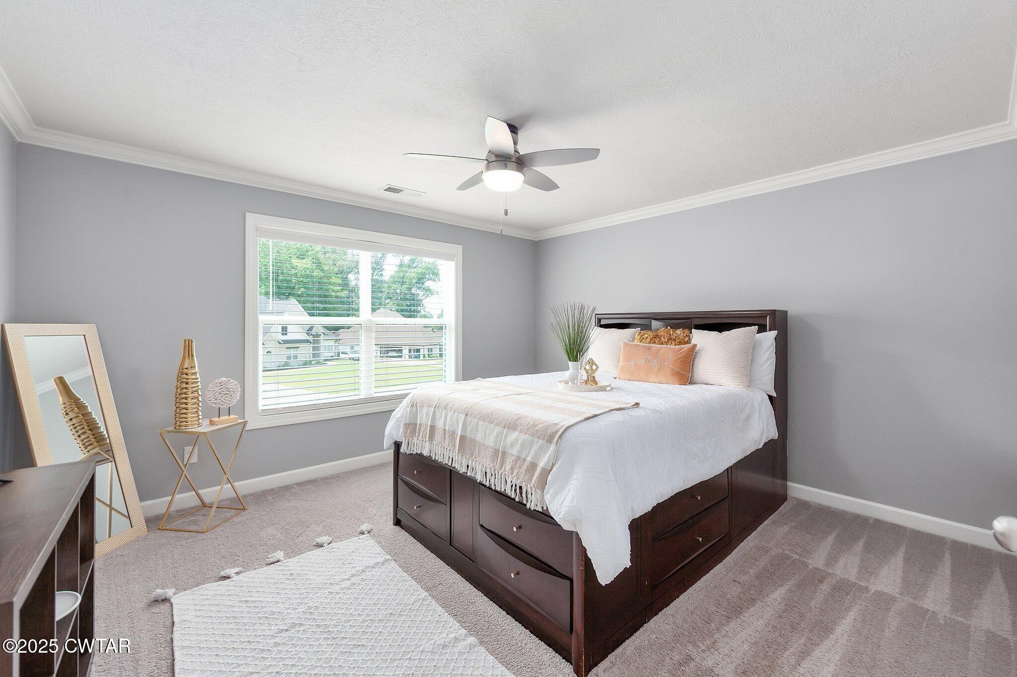63 Westcott Cove Jackson, TN 38305 - Photo 22 of 31 a bed sitting in a bedroom next to a window