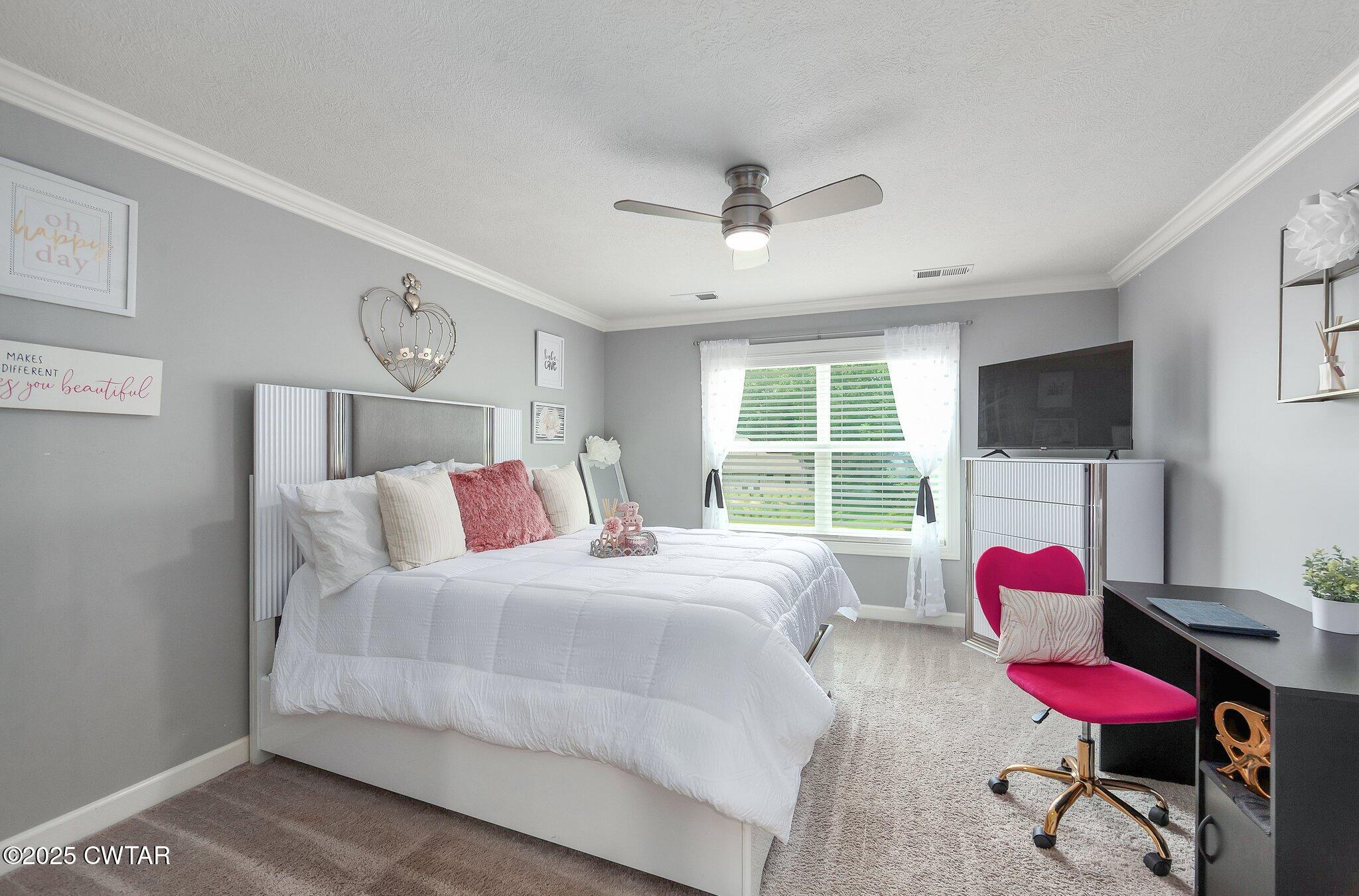 63 Westcott Cove Jackson, TN 38305 - Photo 24 of 31 a bedroom with a bed window and flat screen tv