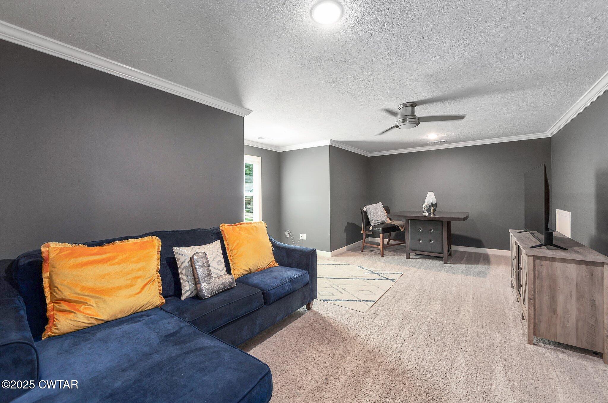 63 Westcott Cove Jackson, TN 38305 - Photo 25 of 31 a living room with furniture and a lamp
