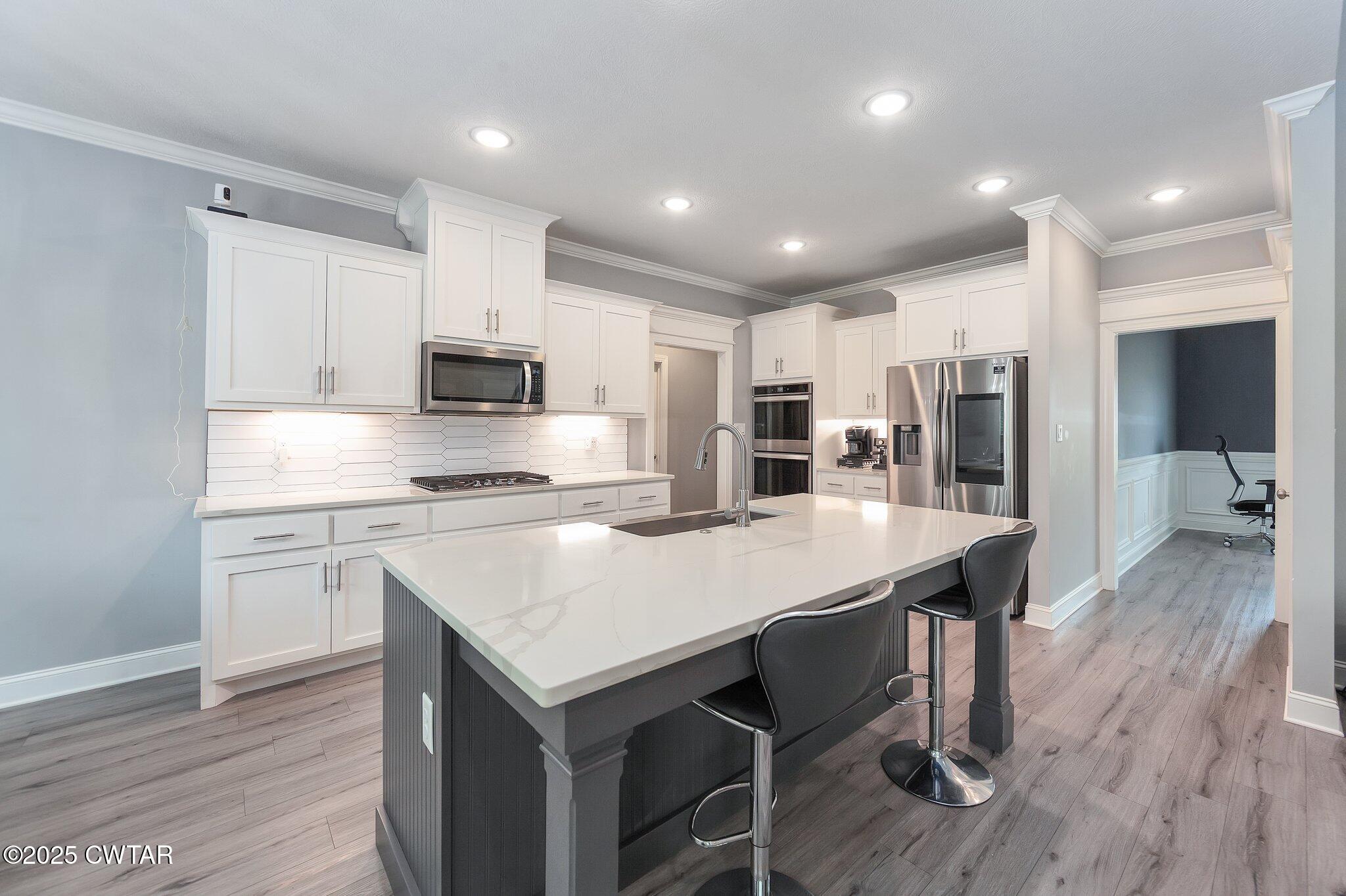 63 Westcott Cove Jackson, TN 38305 - Photo 7 of 31 a kitchen with kitchen island white cabinets and stainless steel appliances