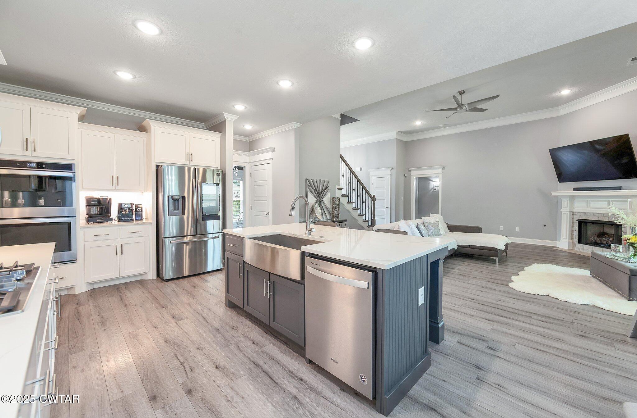 63 Westcott Cove Jackson, TN 38305 - Photo 8 of 31 a kitchen with stainless steel appliances kitchen island granite countertop a stove and a refrigerator