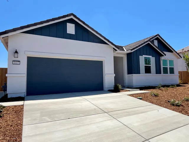 a front view of a house with garage