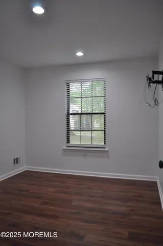 a kitchen with a sink cabinets and wooden floor