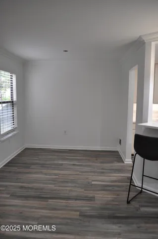 a view of wooden floor and windows in a room