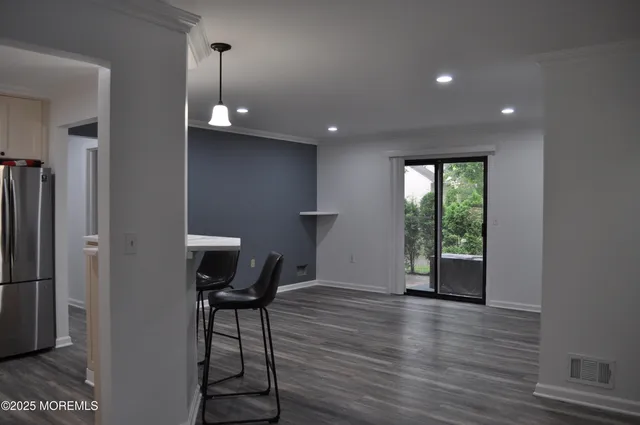 a view of a livingroom with furniture wooden floor and window