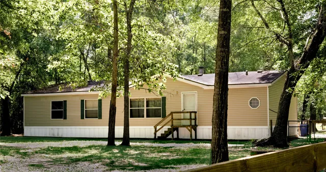 a view of house with backyard