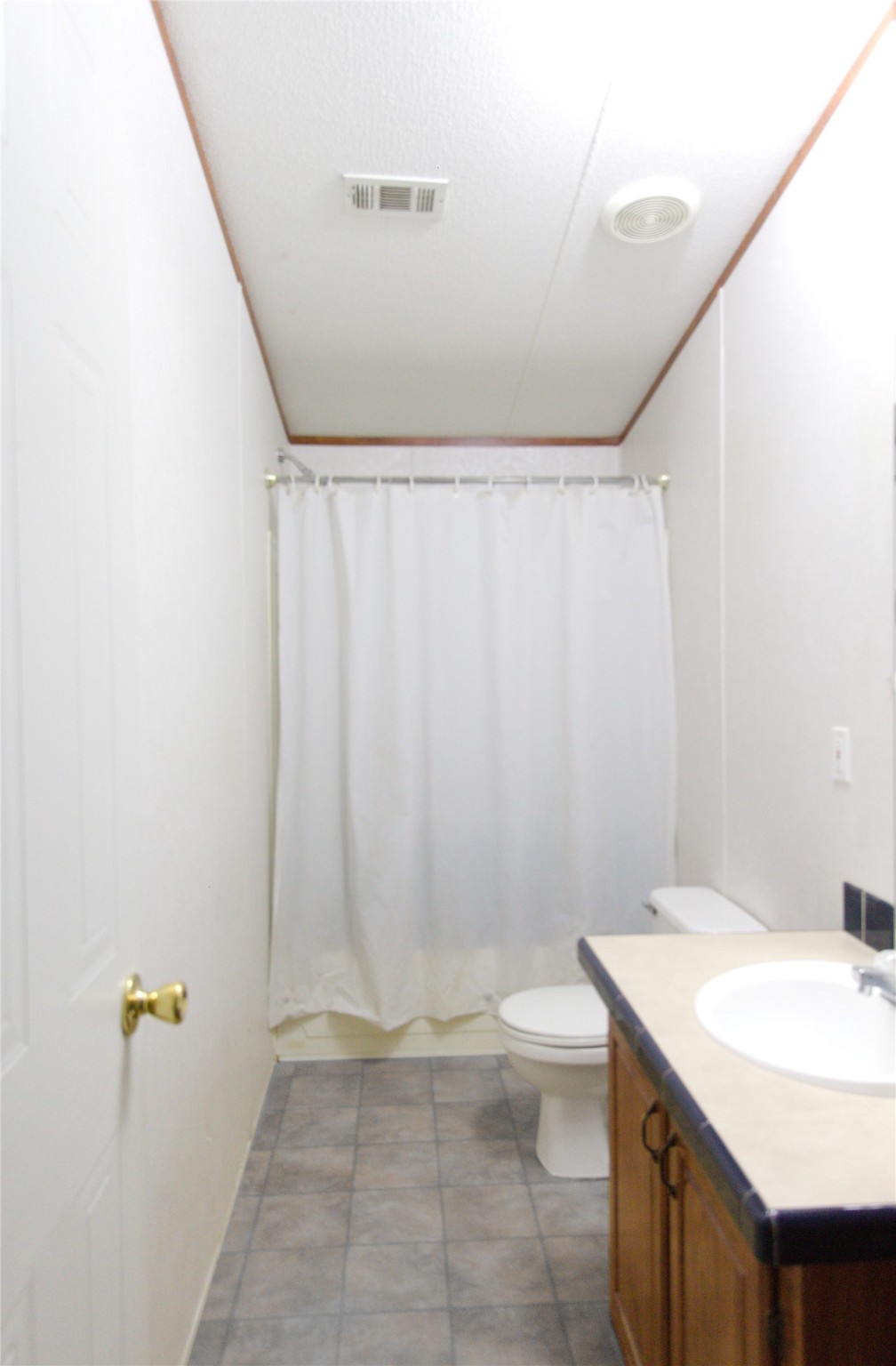 27894 East River Road Splendora, TX 77372 - Photo 12 of 12 a bathroom with a sink a toilet and shower curtain