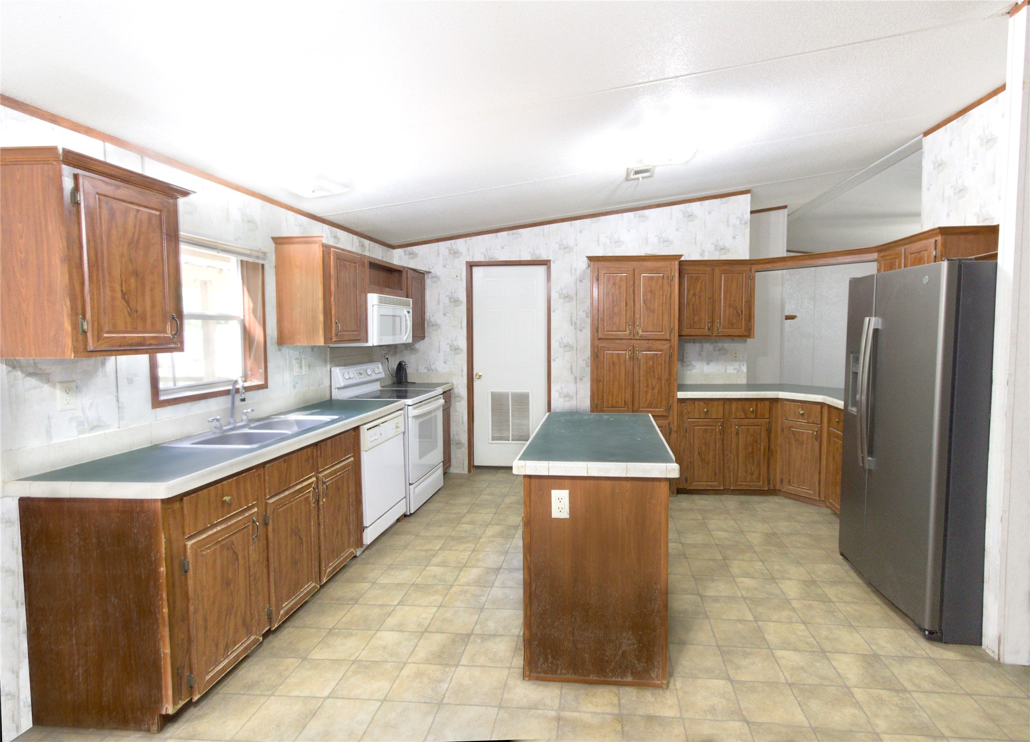 27894 East River Road Splendora, TX 77372 - Photo 7 of 12 a kitchen with stainless steel appliances granite countertop a stove refrigerator and a sink